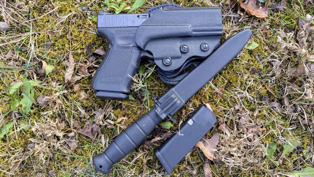 Glock handgun, holster, magazine, and practical firearm gear